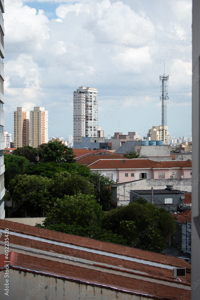 Buildings and threes with a beautiful sky on background