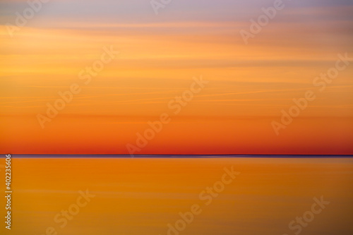 The abstract and minimal landscape of an orange and golden sunset