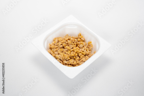 Japanese food: "Hikiwari Natto" or minced fermented soy beans. White background.