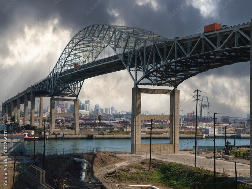 Fototapeta premium View of the old Gerald Desmond bridge above the entrance to the inner harbor at the Port of Long Beach in Los Angeles County, California. 