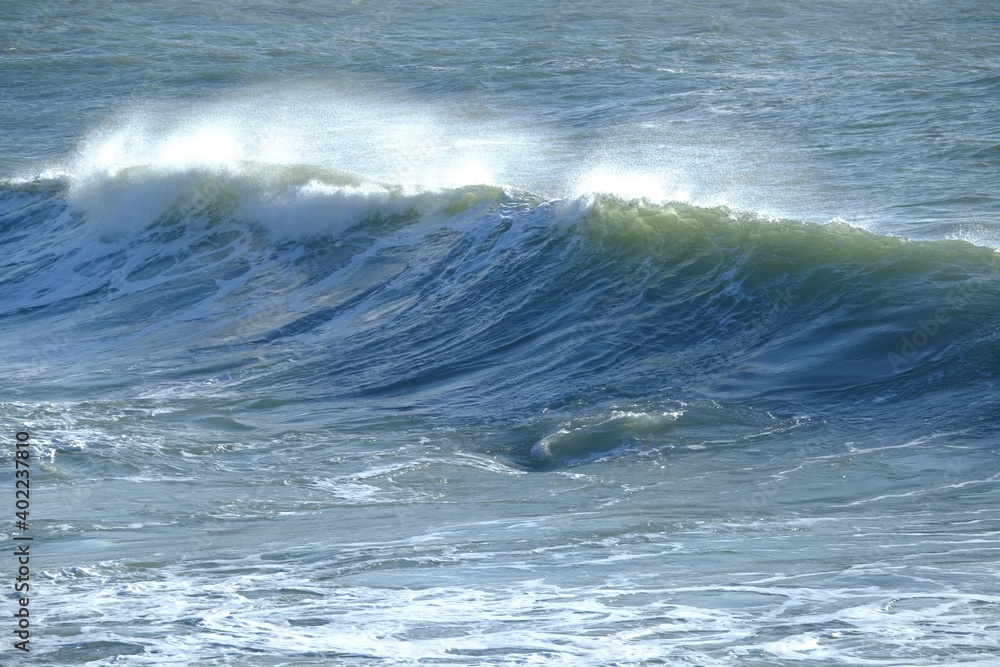 A big wave breaking in the small harbour of Batz sur mer. (West of France, december 2020)