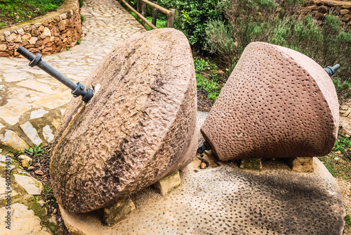 Old traditional stone millstones, exposed outdoors in Spain.