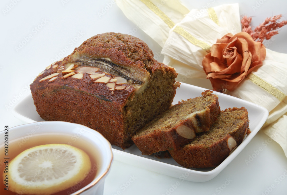 Sliced banana bread with walnuts on white background Sliced banana bread with walnuts on white background