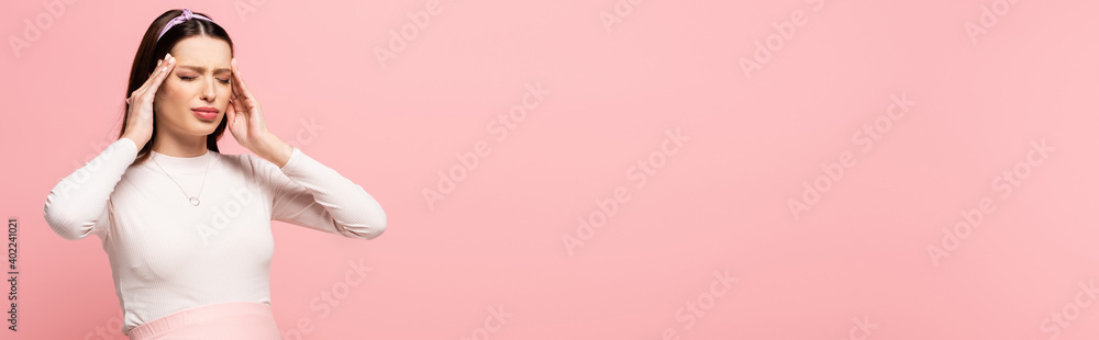 pretty pregnant woman suffering from headache isolated on pink, banner pretty pregnant woman suffering from headache isolated on pink, banner
