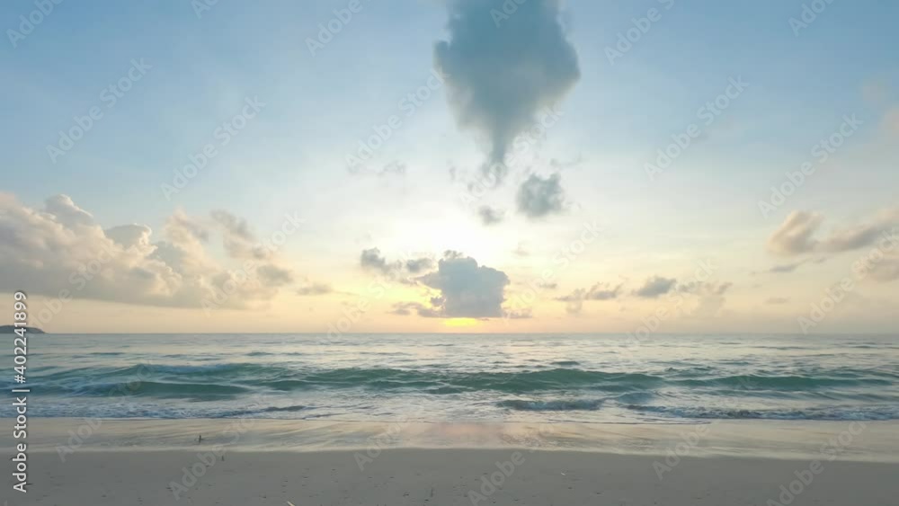 morning sky sunrise over sea. ocean waves swap on sandy beach, golden sunlight shine on water surface, fluffy clouds spreading out over sky space. tropical beach in summer rainy season. travel nature morning sky sunrise over sea. ocean waves swap on sandy beach, golden sunlight shine on water surface, fluffy clouds spreading out over sky space. tropical beach in summer rainy season. travel nature