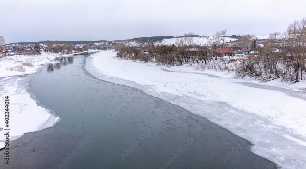 The spring river in the village began to thaw from the ice.The ice in the river began to melt.