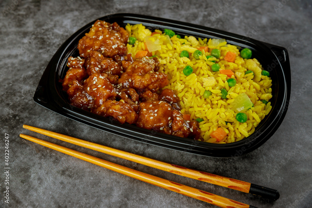 Teriyaki chicken in sweet and sour sauce with rice on tray. Teriyaki chicken in sweet and sour sauce with rice on tray.