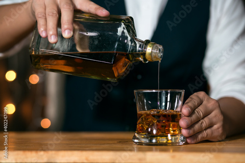 Bartender Serve Whiskey  on wood bar