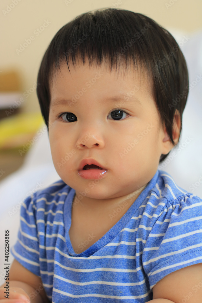 close-up of adorable asian Baby girl make a face like interested something close-up of adorable asian Baby girl make a face like interested something