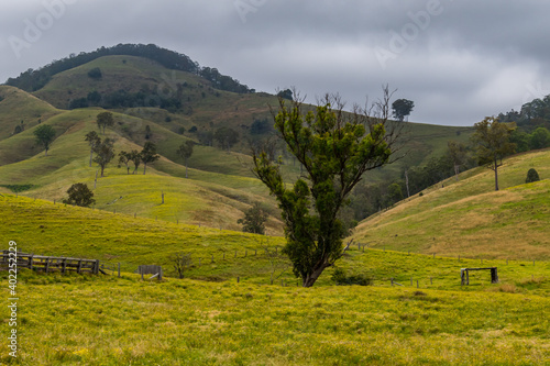 Overcast day in the country surrounded by rural land and hills photo