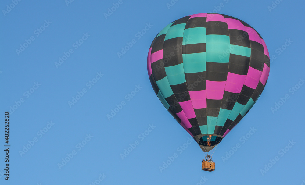 Naklejka premium Peaceful flight over sunny Arizona in a brightly colored Hot Air Balloon. Maricopa County, Arizona
