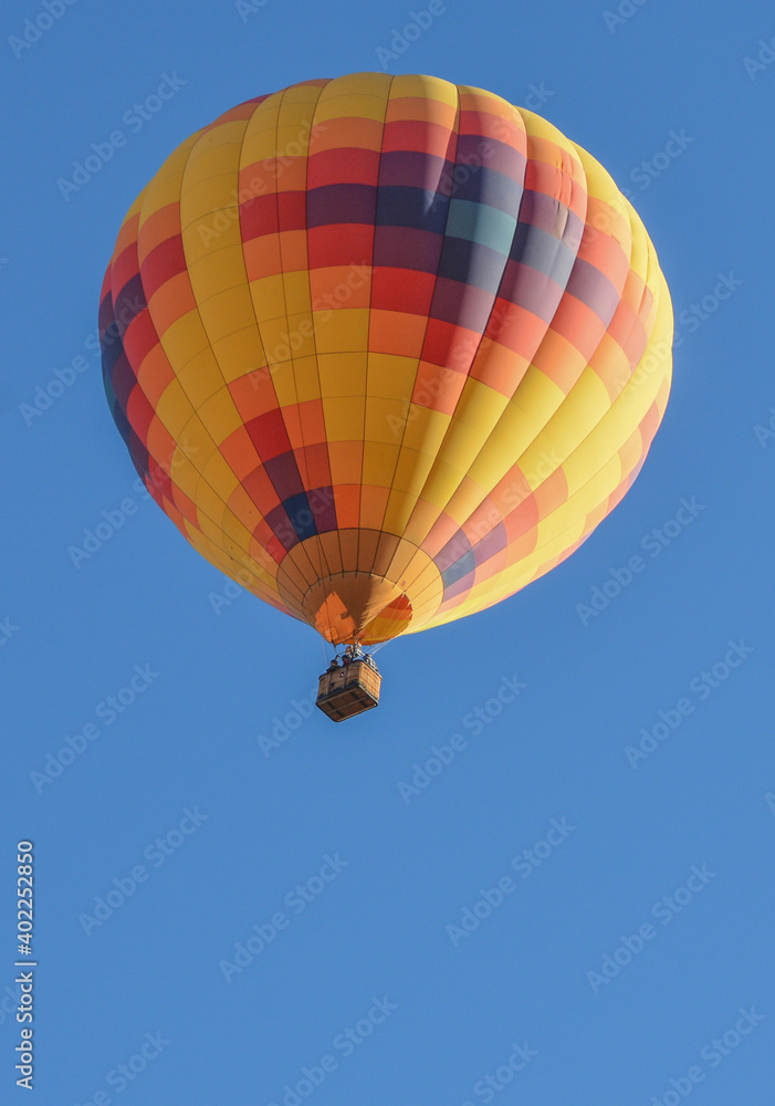 Fototapeta premium Peaceful flight over sunny Arizona in a brightly colored Hot Air Balloon. Maricopa County, Arizona