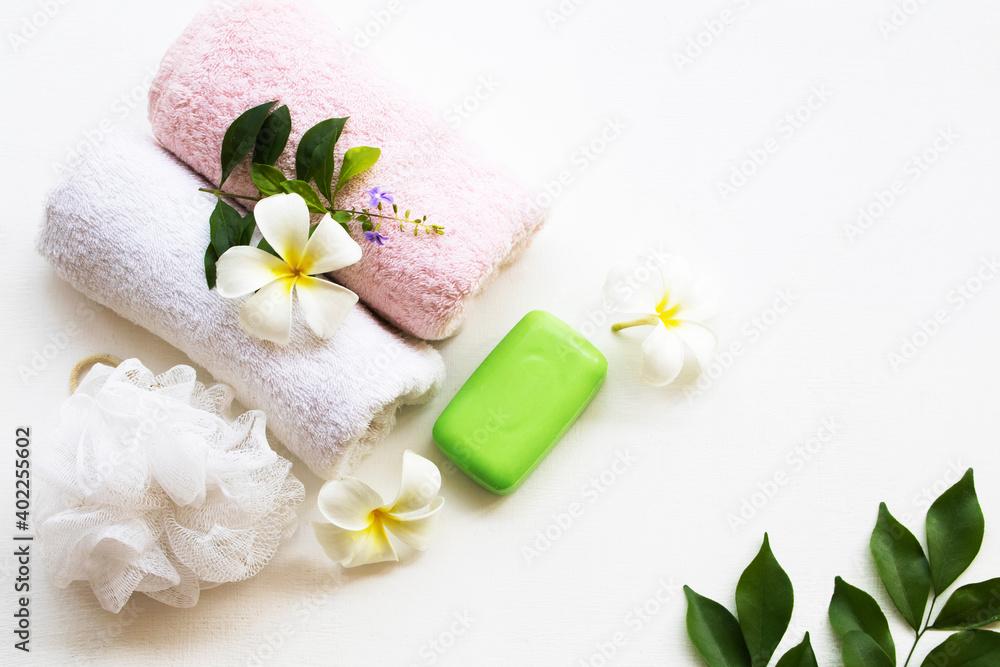 herbal soap with terry cloth health care for body skin cleaning to a bath with flower frangipani arrangement flat lay style on background white herbal soap with terry cloth health care for body skin cleaning to a bath with flower frangipani arrangement flat lay style on background white