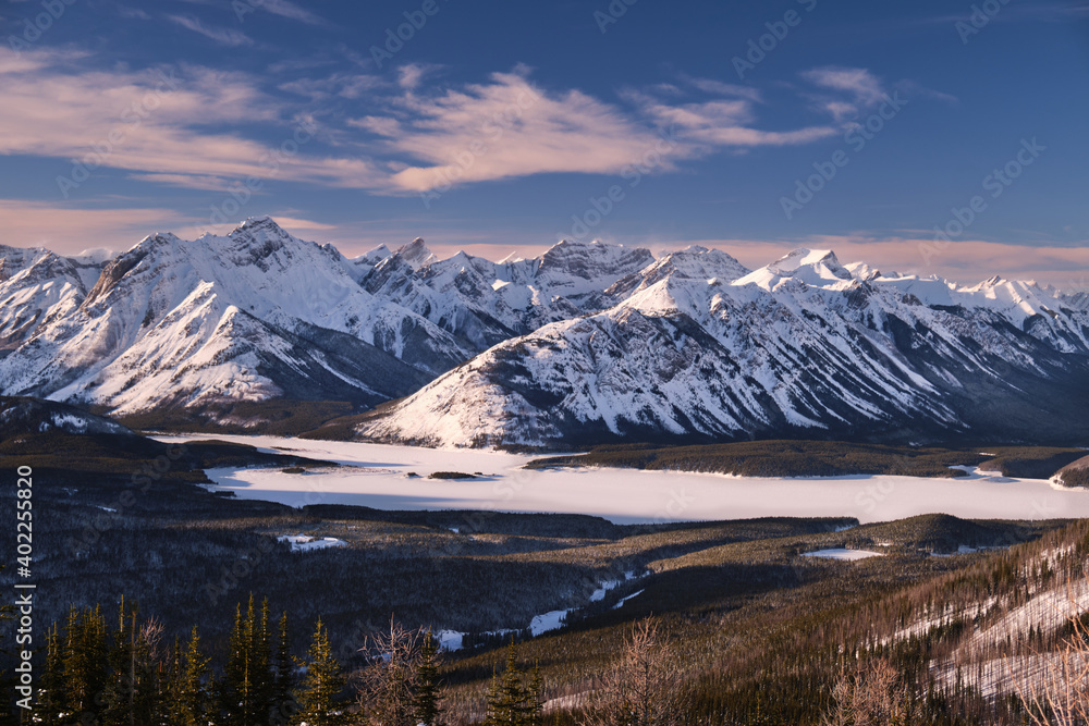 Winter landscape with snow covered mountains and frozen lake. View from Rummel ridge in Kananaskis.  Canadian Rockies. Alberta. Canada. 