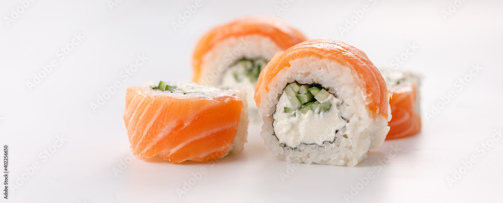 Philadelphia roll sushi on a white plate. Isolated. Restaurant concept. Close-up. Philadelphia roll sushi on a white plate. Isolated. Restaurant concept. Close-up.