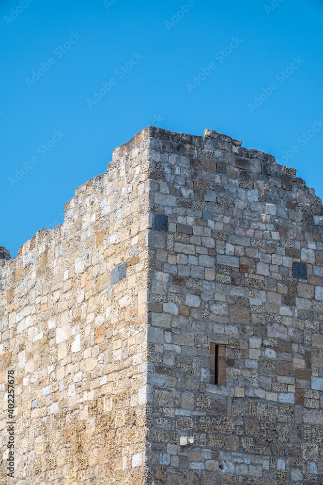 Ruins of the fortress wall against the blue sky