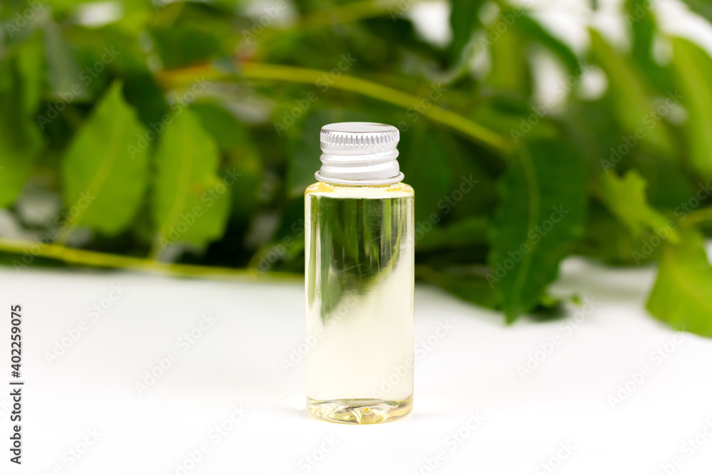 neem oil in bottle and neem leaf isolate on white background. neem oil in bottle and neem leaf isolate on white background.