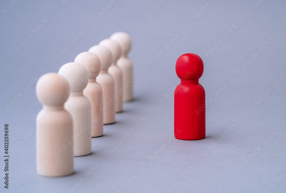 Leadership concept, red figure of a man made of wood, standing out from the crowd of. Different people. Run to new opportunities. Talent management, Recruitment employee, Good business team leader. Leadership concept, red figure of a man made of wood, standing out from the crowd of. Different people. Run to new opportunities. Talent management, Recruitment employee, Good business team leader.