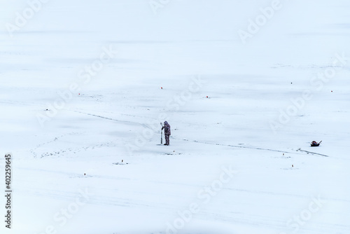 Fisherman on the ice of a frozen river.
