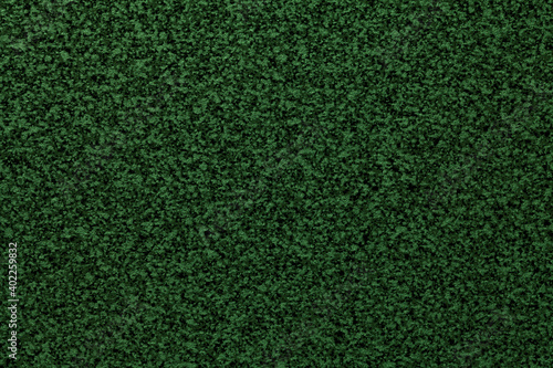 Grainy dark green smooth background of tabletop. Texture abstract surface.
