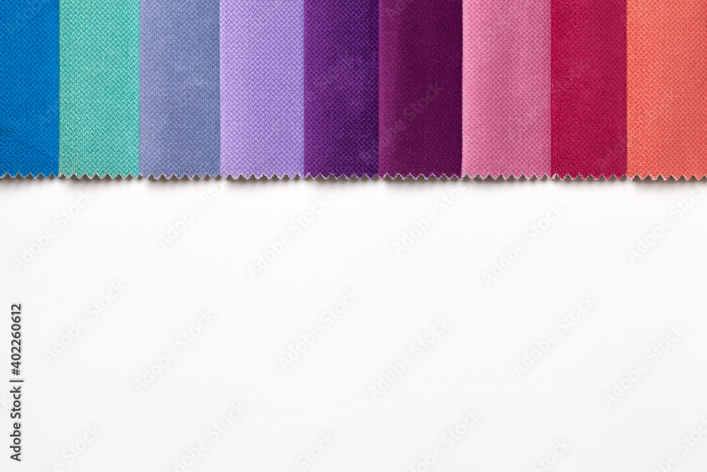 Fototapeta premium Sample of velvet textile various colors, background on white table with space.
