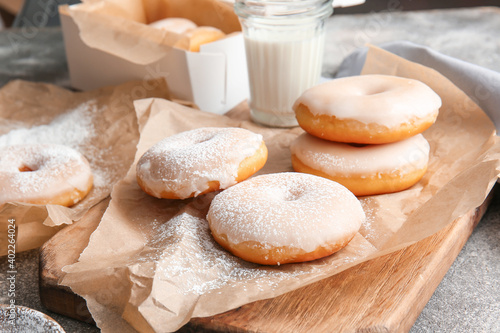 Tasty donuts on grey table
