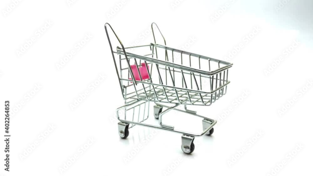 empty metallic miniature toy shopping cart on white background empty metallic miniature toy shopping cart on white background