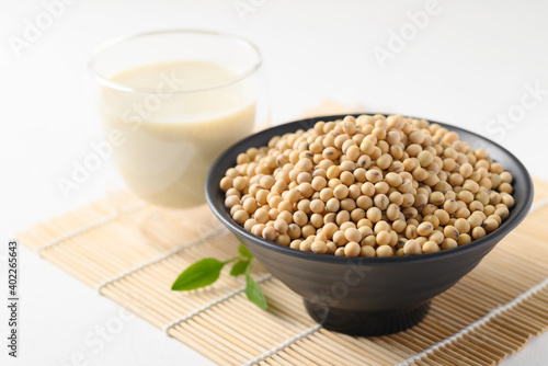Soybeans seed in a black bowl and soy milk in a glass, Healthy drink