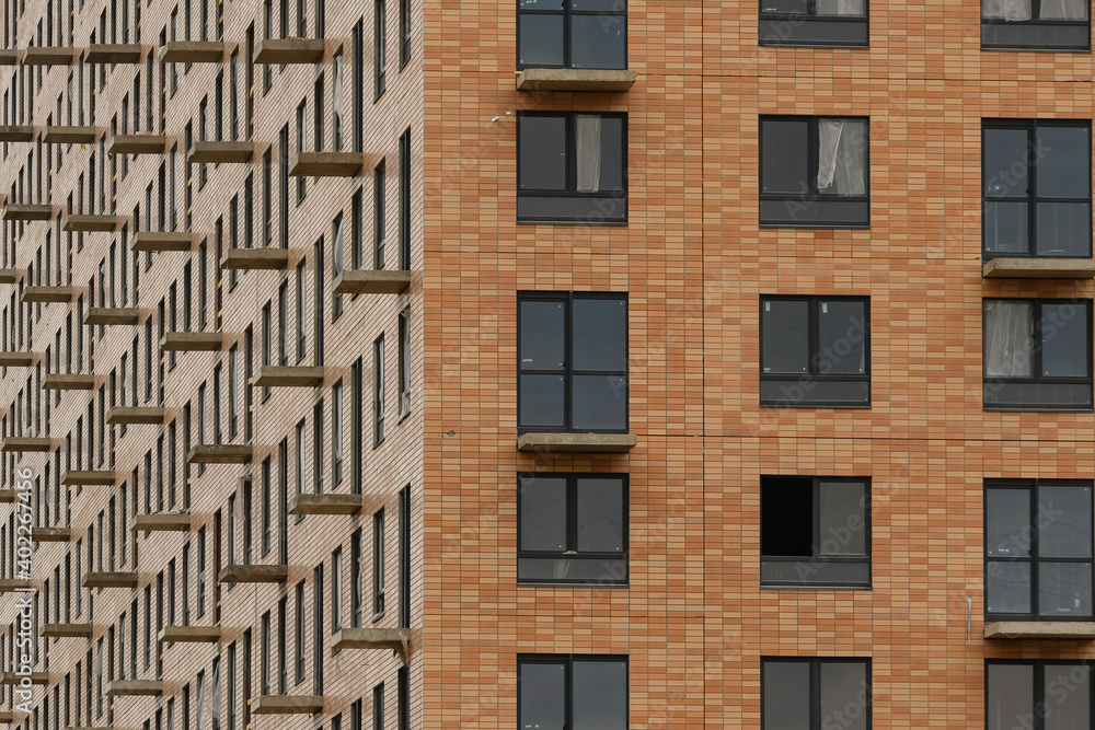 Facade with windows of an unfinished building, closeup house