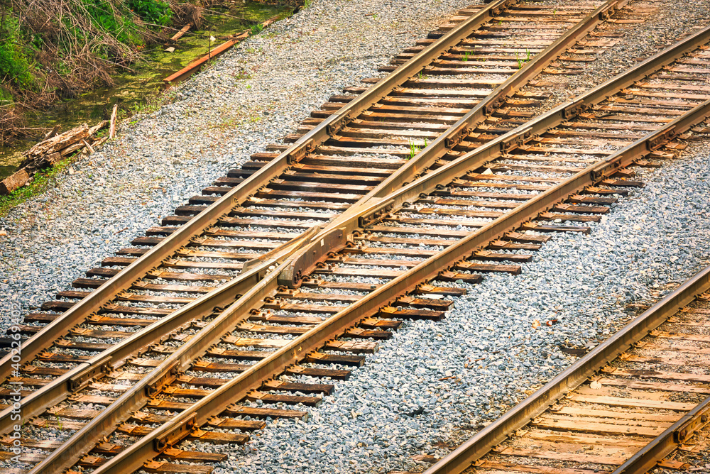 Fototapeta premium A high angle view of railroad tracks splitting off into 2 different directions.