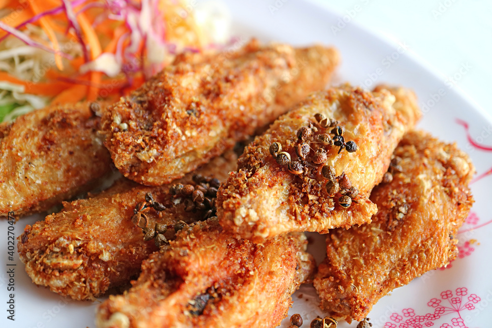 Closeup Thai Northern Style Deep Fried Chicken Wings with Hot and Spicy Herbs
