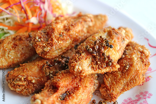 Closeup Thai Northern Style Deep Fried Chicken Wings with Hot and Spicy Herbs