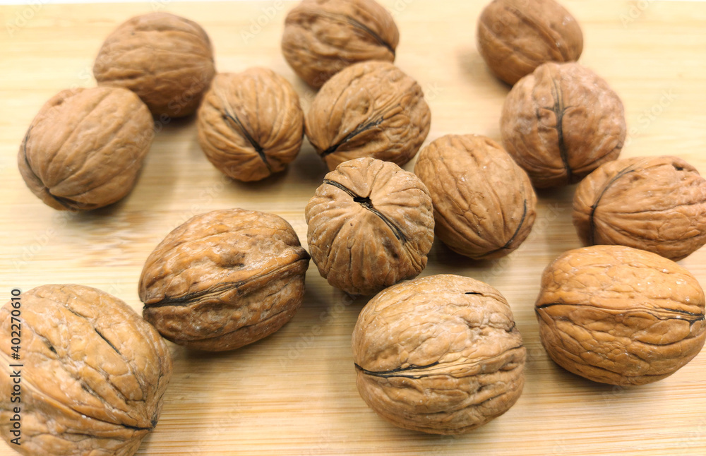 walnuts on a wooden table walnuts on a wooden table