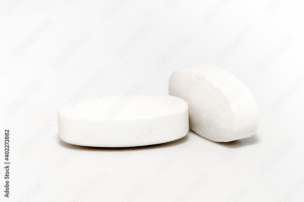 White tablets of medicine isolated on white background White tablets of medicine isolated on white background