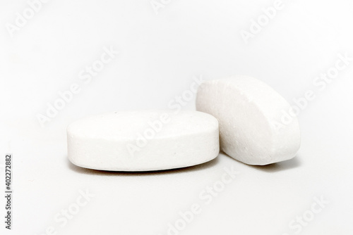 White tablets of medicine isolated on white background