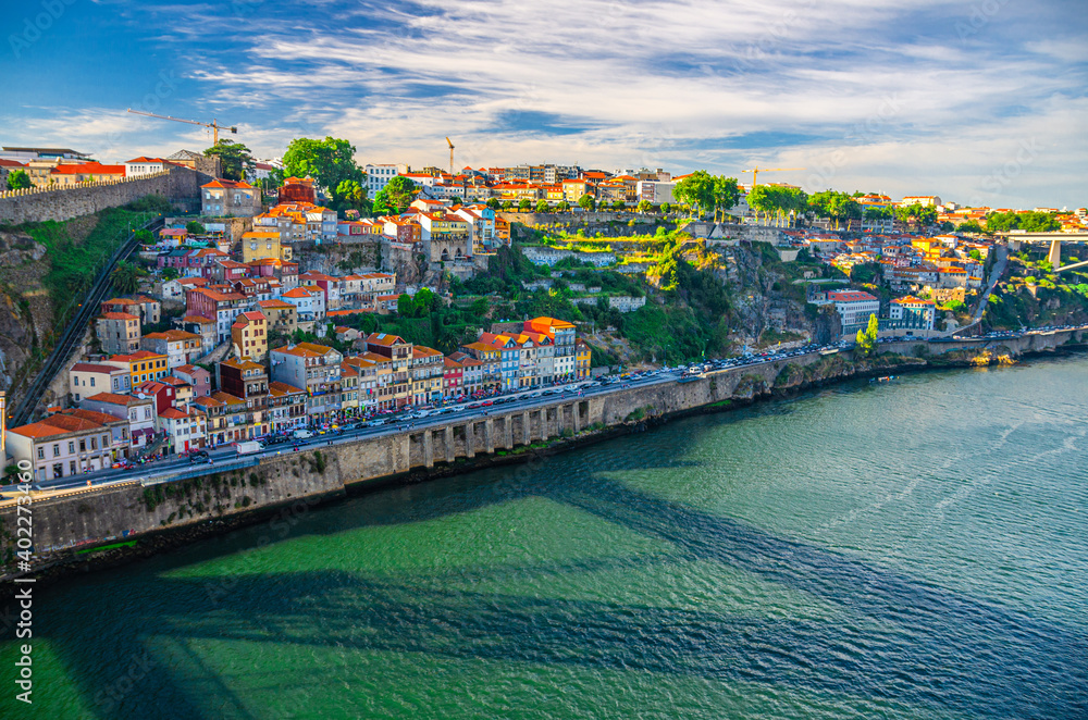 Aerial panoramic view of Porto Oporto city with colorful buildings and traditional houses on steep slope and embankment of Douro River, Norte or Northern Portugal
