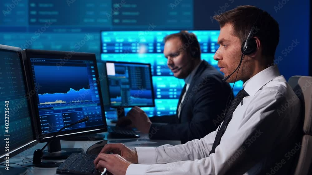 Team of brokers is working in office using workstation and analysis technology. Workplace of professional traders. Global financial markets, business, currency exchange and banking concepts. Team of brokers is working in office using workstation and analysis technology. Workplace of professional traders. Global financial markets, business, currency exchange and banking concepts.