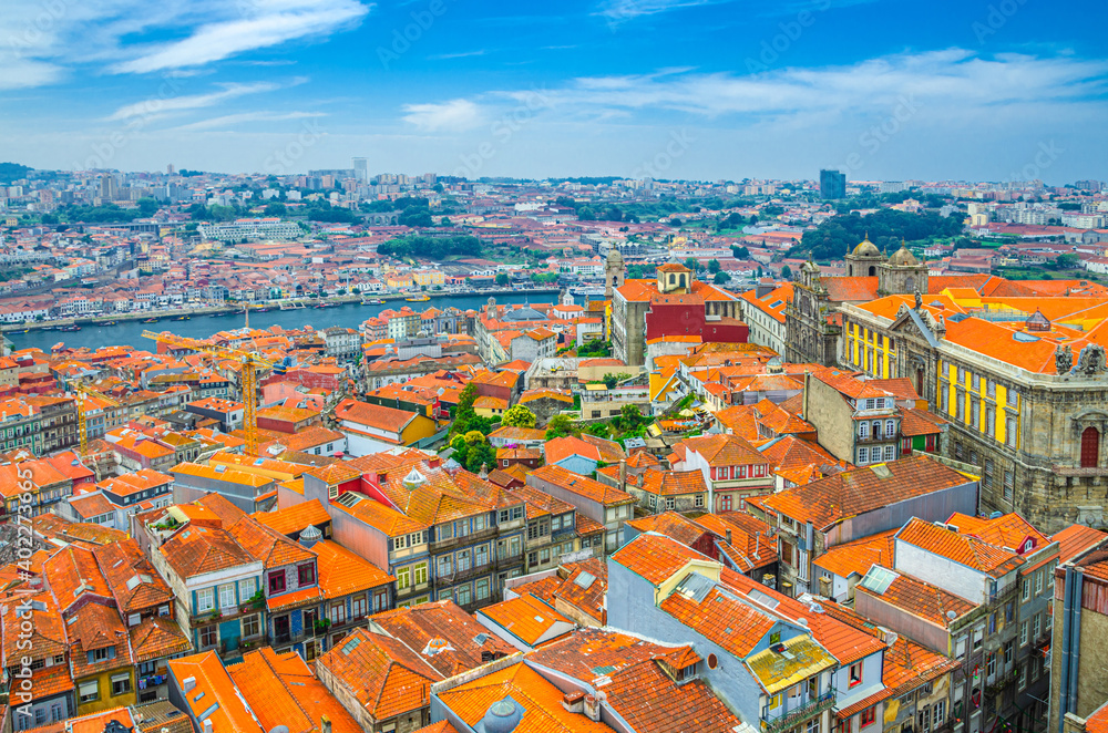 Aerial panoramic view of Porto Oporto city historical centre with red tiled roof typical buildings, Douro River, Igreja de Sao Bento da Vitoria church and Vila Nova de Gaia city, Northern Portugal