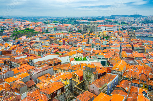 Aerial panoramic view of Porto Oporto city historical centre with red tiled roof typical buildings, Porto Cathedral, Douro River and Vila Nova de Gaia city background, Norte or Northern Portugal