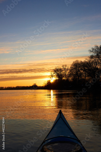 Prow of blue kayak. Kayaking in winter on the river.