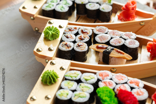 Set of maki sushi on wooden boat tray