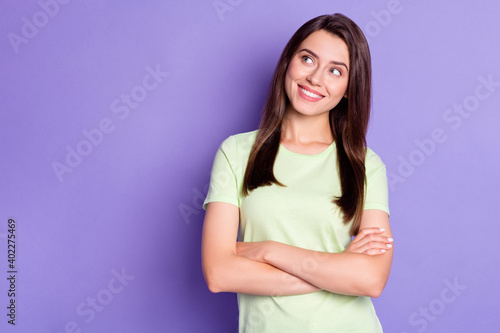 Photo portrait of dreamy curious brunette with folded hands smiling isolated on bright violet color background with blank space