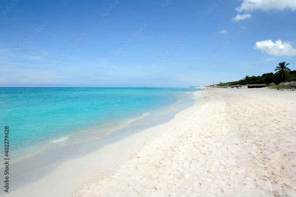 Remote tropical beach with fine white sand, clear turquoise blue water and few tourists in Varadero, Matanzas province, most famous beach resort in Cuba and one of the largest resorts in the Caribbean