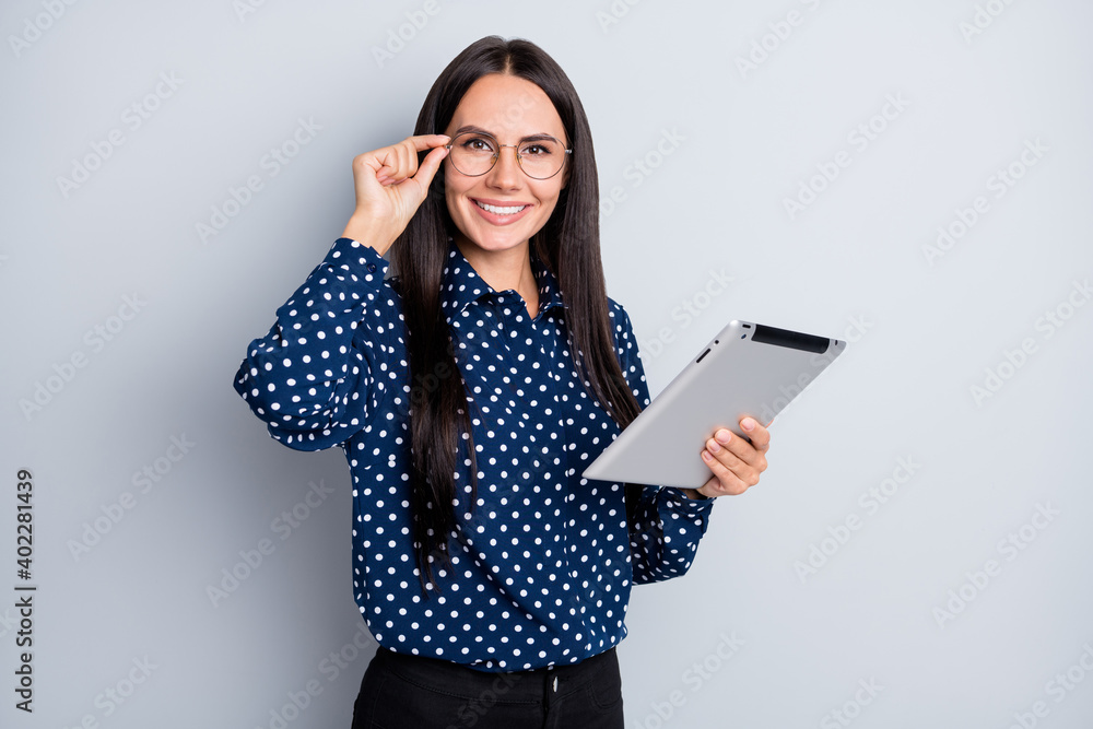 Portrait of pretty skilled cheerful businesslady using gadget browsing analyse report isolated over grey pastel color background Portrait of pretty skilled cheerful businesslady using gadget browsing analyse report isolated over grey pastel color background