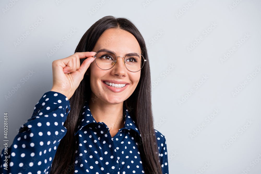 Photo of young attractive pretty smiling confident businesswoman in glasses look copyspace isolated on grey color background Photo of young attractive pretty smiling confident businesswoman in glasses look copyspace isolated on grey color background