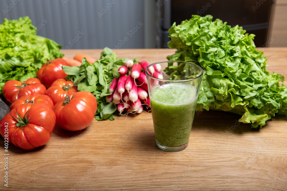 Vegan woman making vegetable juice for detox Vegan woman making vegetable juice for detox