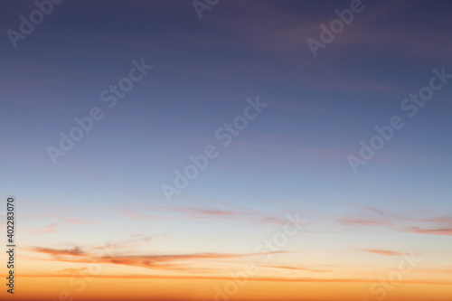 Heaven at early morning with copy space. Sunset, sunrise backdrop.Predawn clear sky with orange horizon and blue atmosphere. Smooth orange blue gradient of dawn sky.