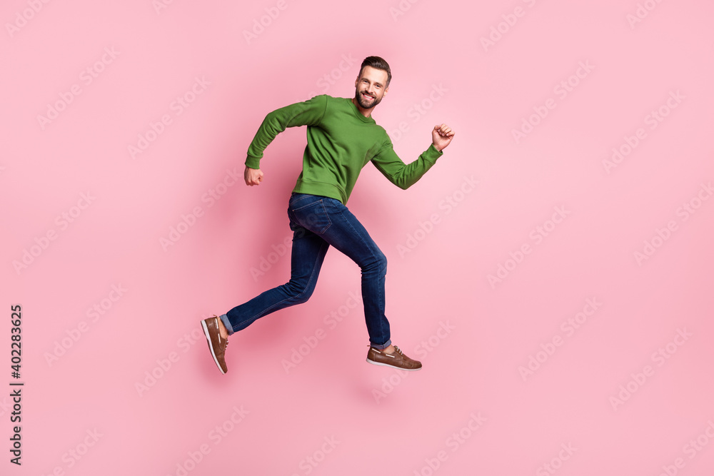 Full length body size profile side view of attractive cheerful guy jumping running fast isolated over pink pastel color background - obrazy, fototapety, plakaty 