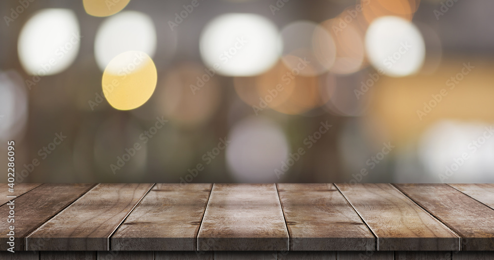 Empty wooden table top with lights bokeh on blur restaurant background. Empty wooden table top with lights bokeh on blur restaurant background.