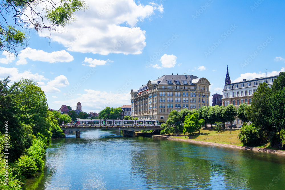 Beautiful cityscape of the city of Strasbourg, France with the Ill river and a bridge and beautiful city houses in the background. Beautiful cityscape of the city of Strasbourg, France with the Ill river and a bridge and beautiful city houses in the background.